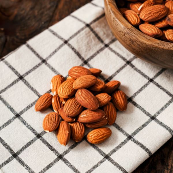 Roasted almonds from Fresh Nuts in a 0.25 kg pack, showing golden-brown crunchy nuts on a white background.