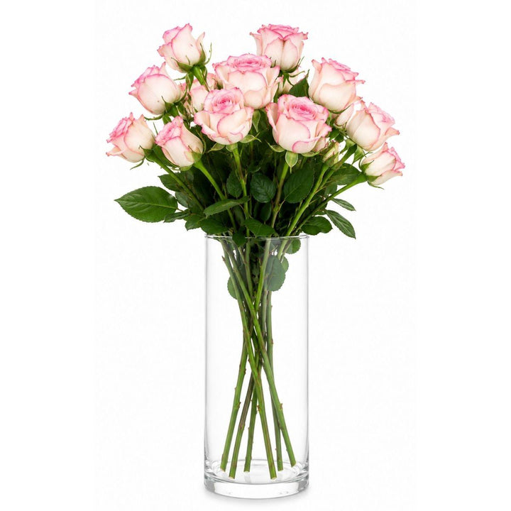 Pink roses arranged in a tall clear glass vase, from Sharbatly.