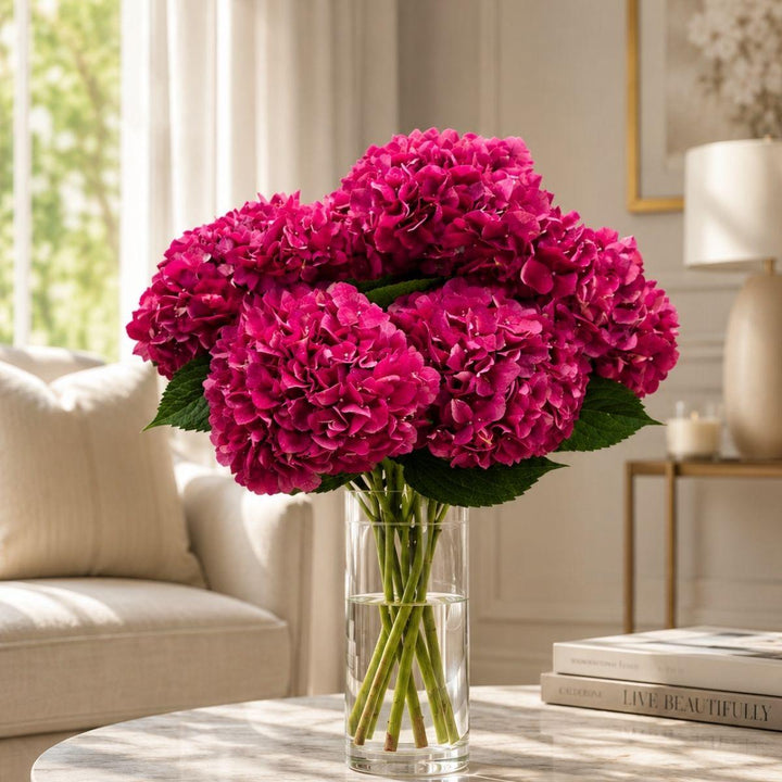Red Trophy hydrangeas arranged in a clear vase at home, from Sharbatly.