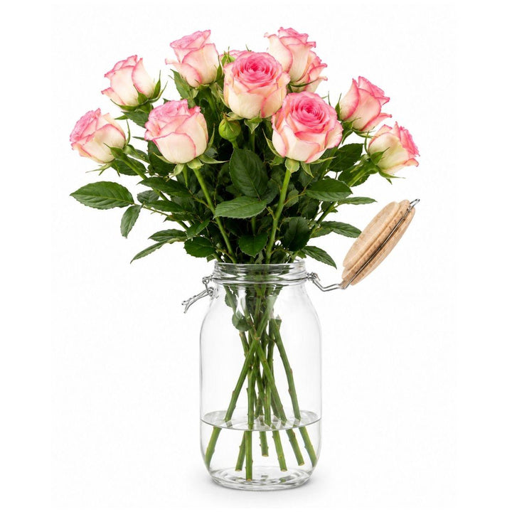 Pink roses arranged in a glass jar with a wooden lid, from Sharbatly.