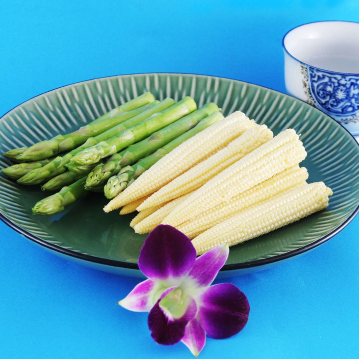 Baby asparagus and baby corn served together on a plate, from Sharbatly.