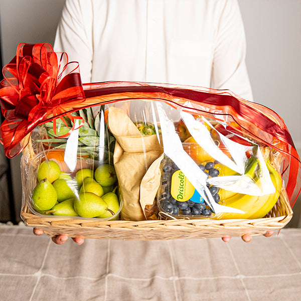 Mixed brand luxury fresh mix fruit gift basket with a variety of colorful, ripe fruits arranged in a decorative basket.