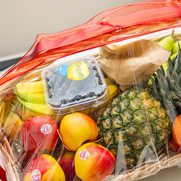 Mixed brand luxury fresh fruit gift basket with assorted colorful fruits in a woven basket.