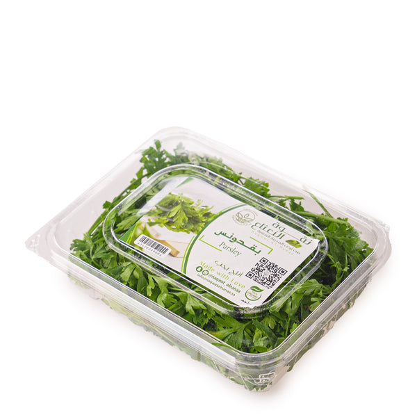 Fresh organic parsley flat herb in a 0.13 kg pack from Naqwat Al Nana, shown in a close-up image.