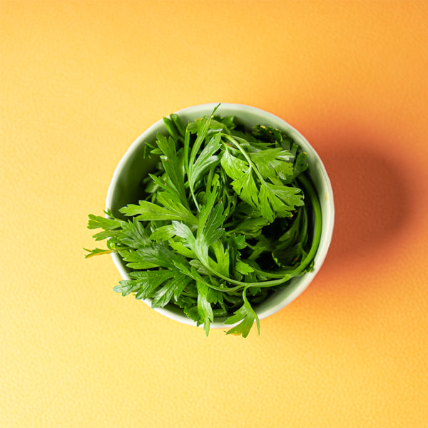 Fresh organic parsley flat herb from Naqwat Al Nana in a 0.13 kg pack, showing vibrant green leaves.