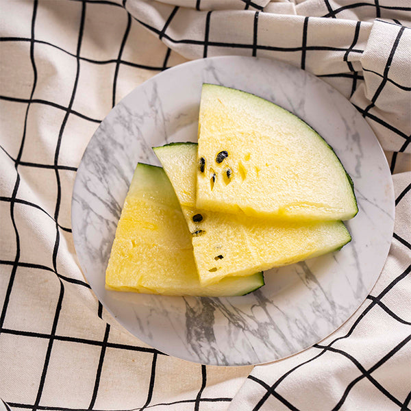 Fresh yellow baby watermelon from Local Market, showcasing its vibrant color and smooth, round shape perfect for snacking.