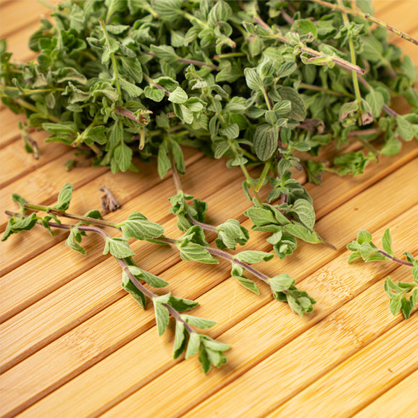 Organic wild thyme and zaatar herb mix in a 0.15 kg pack, displayed in a clear container with fresh herbs.