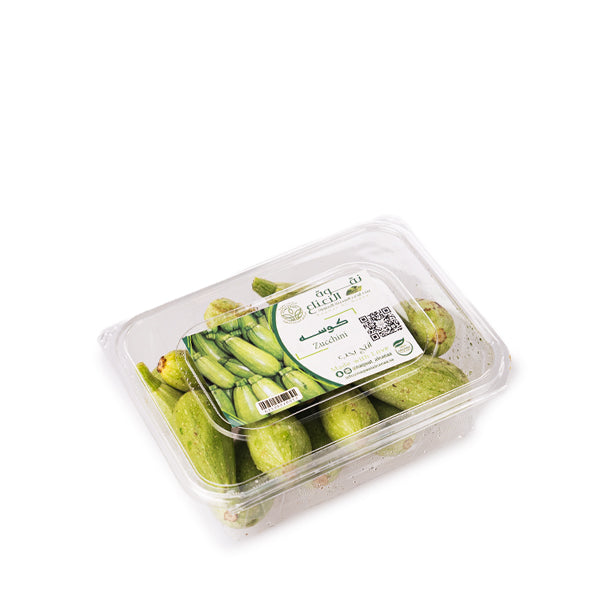 Fresh organic green zucchini vegetables from Naqwat Al Nana in a 0.75 kg pack, shown in the image.