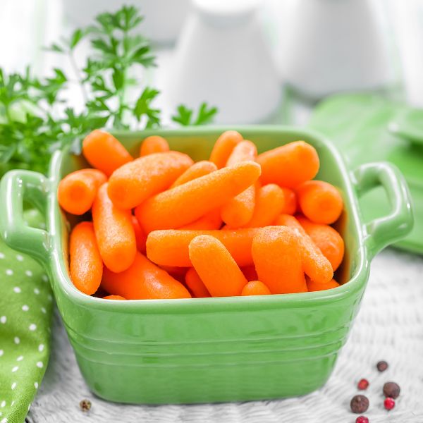 Fresh baby carrots from Sharbatly in a 0.34 kg bag, showcasing vibrant orange vegetables suitable for snacking and cooking.