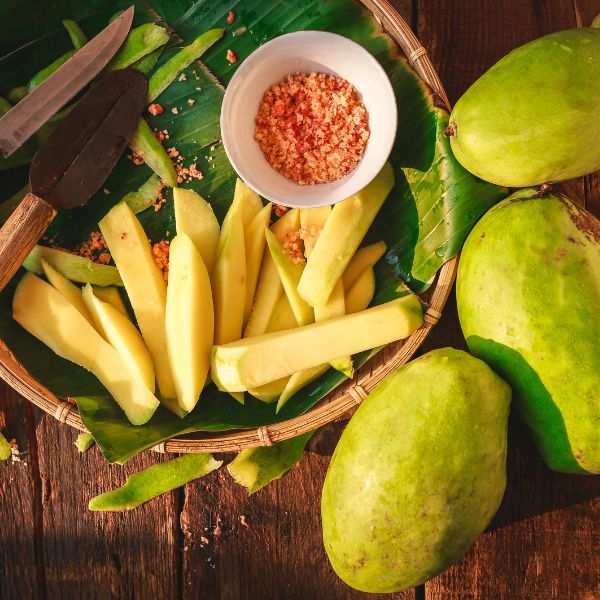 Fresh jasmine mangoes in a 3 kg carton from Local Market, showcasing ripe, fragrant tropical fruit in a natural setting.