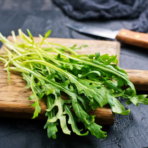 Fresh baby hydroponic rucola leaves in a 0.125 kg pack, showcasing vibrant green vegetable from Mishkat.