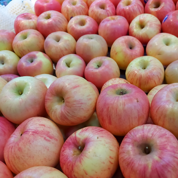 Fresh Fuji apples from Sharbatly, 1 kg pack, showing bright red and yellow skin with a smooth surface.