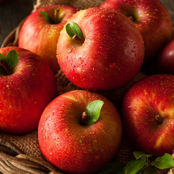 Fresh Fengapi Tessa apples from Sharbatly, 1 kg pack, showcasing shiny red and green fruit on a natural background.