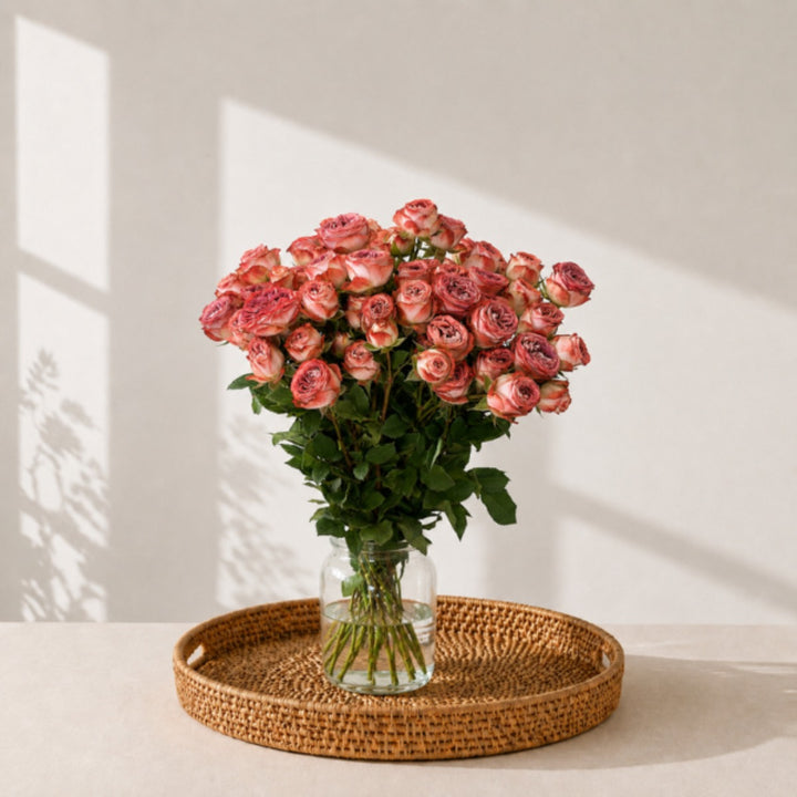 Bouquet of 10 spray roses from Vegpro Kenya in a garden setting, showcasing vibrant blooms and lush green stems.