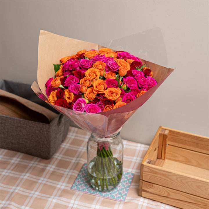 Baby roses in a Carnival Luxury Bouquet with 30 stems, arranged in a colorful mixed flower bouquet.