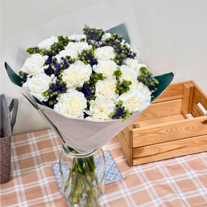 Mix Flower Bouquet with 30 stems of vibrant carnations and eryngium, arranged in a colorful floral bouquet.