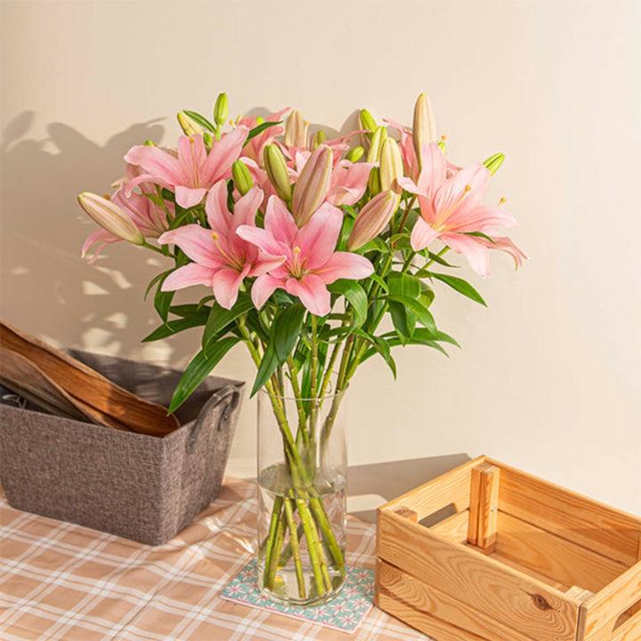 Pink Asiatic lilies from Flowranow with 10 stems, showing vibrant blooms and green stems in a natural floral arrangement.