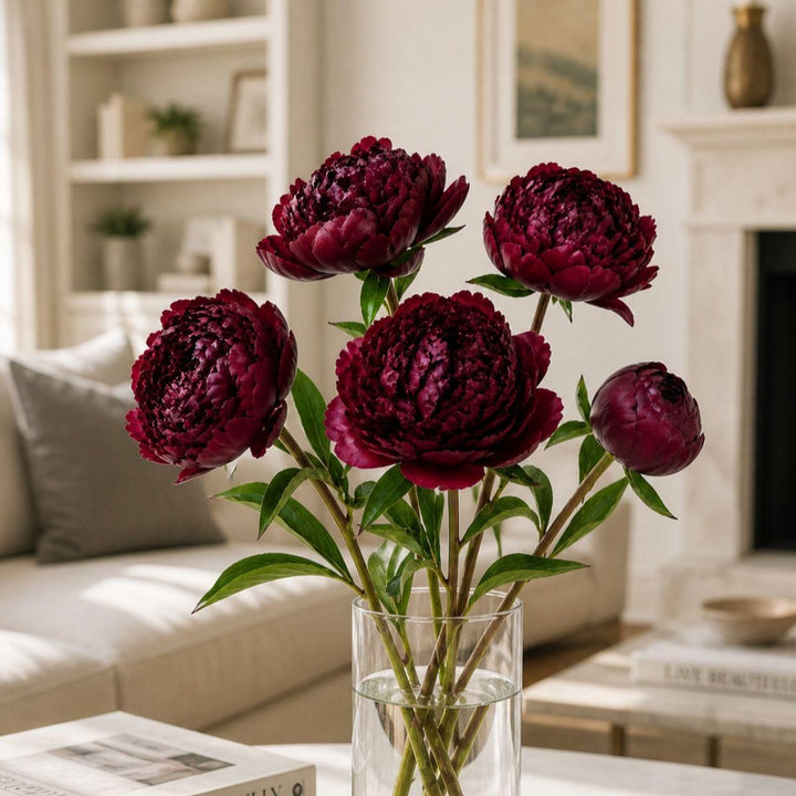 Red peony flowers from Fresh Flower Holland with five stems, showcasing full, vibrant blooms and lush green foliage.
