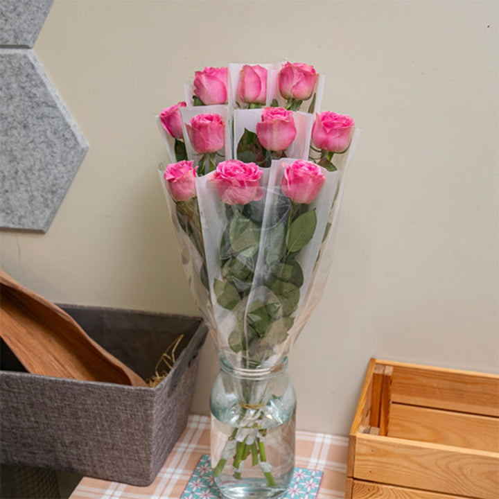 Pink rose flower from SQ Flora Kenya, single stem individually wrapped, showcasing vibrant petals and fresh floral beauty.