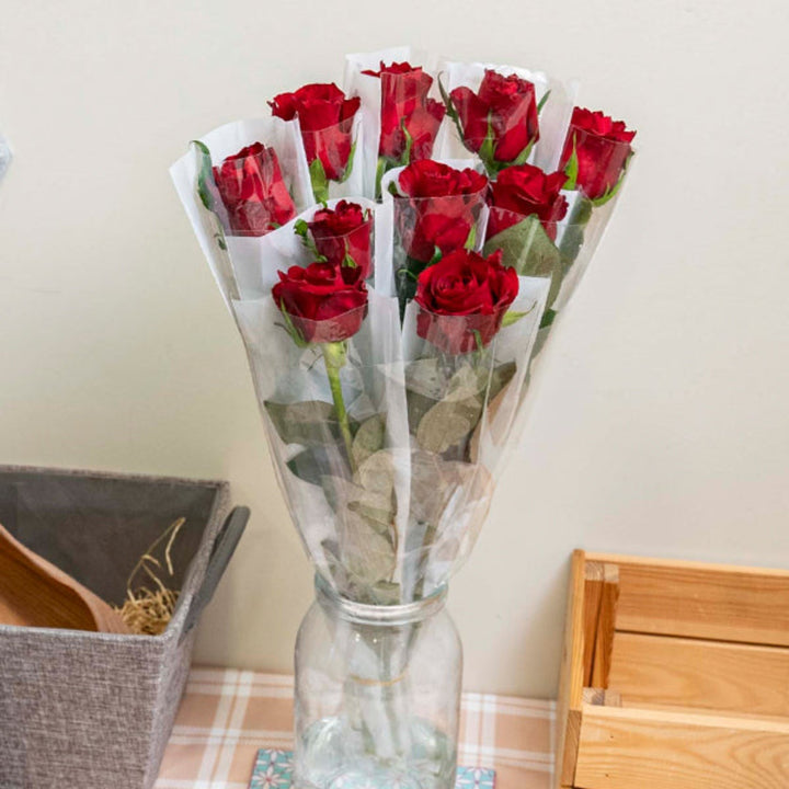 Red rose flower from SQ Flora Kenya, a single stem with vibrant petals, individually wrapped for freshness and presentation.
