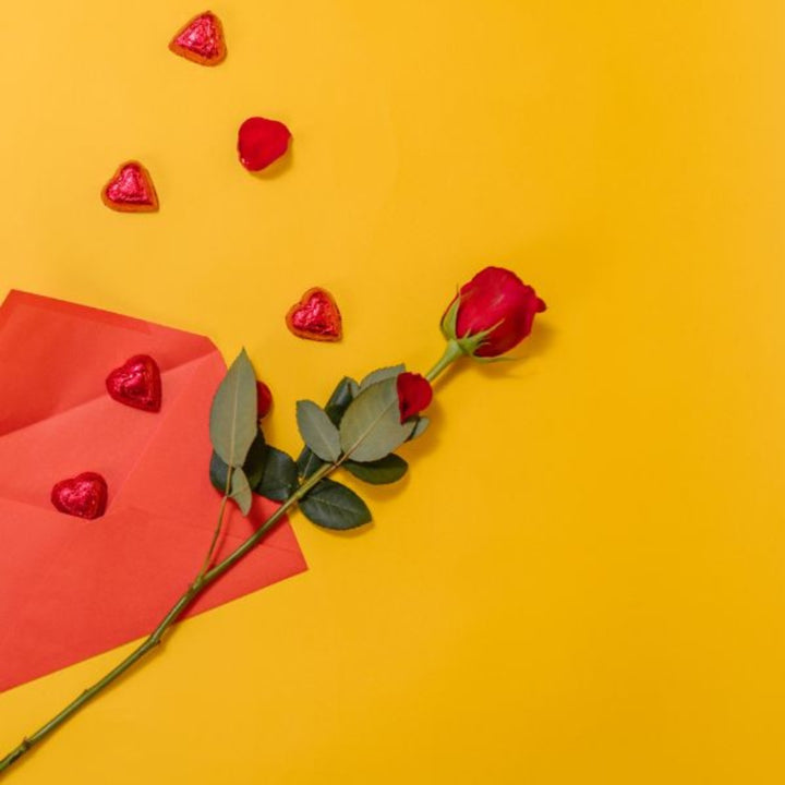 Single red rose flower from SQ Flora Kenya, showcasing a vibrant, fresh blossom with green stem and leaves.