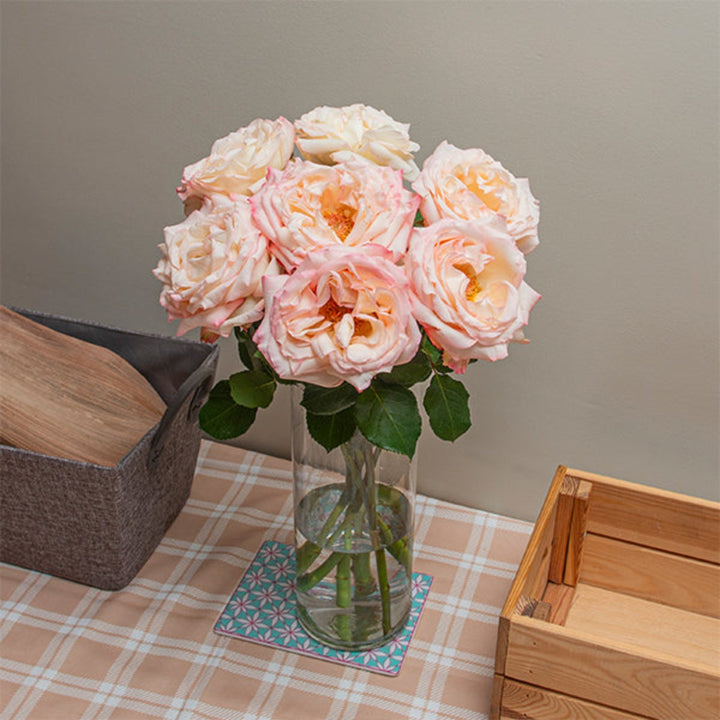 Pink scented Joyce rose flower with 8 stems, vibrant blooms, and lush green leaves, from Vegpro Kenya.