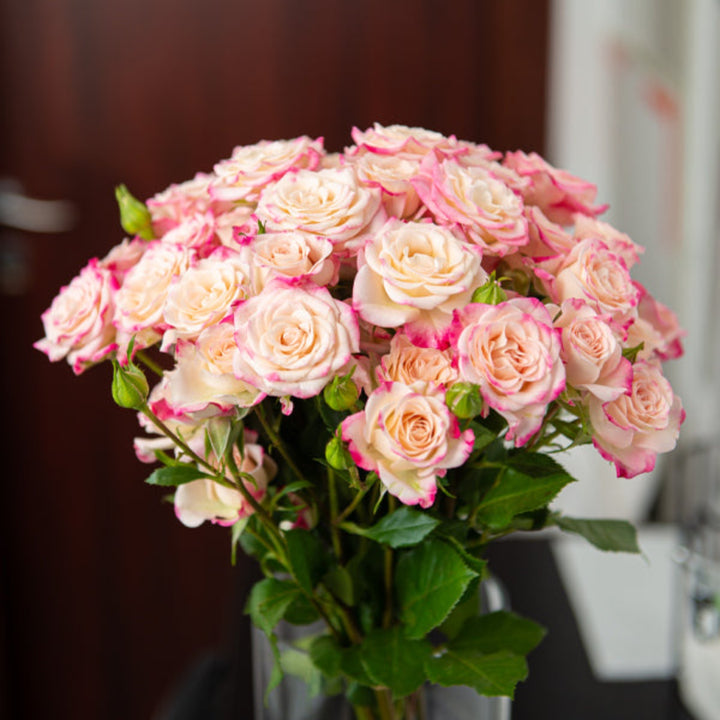 Bouquet of 10 pink roses from SQ Flora Kenya, featuring vibrant baby reflex roses in a natural floral display.