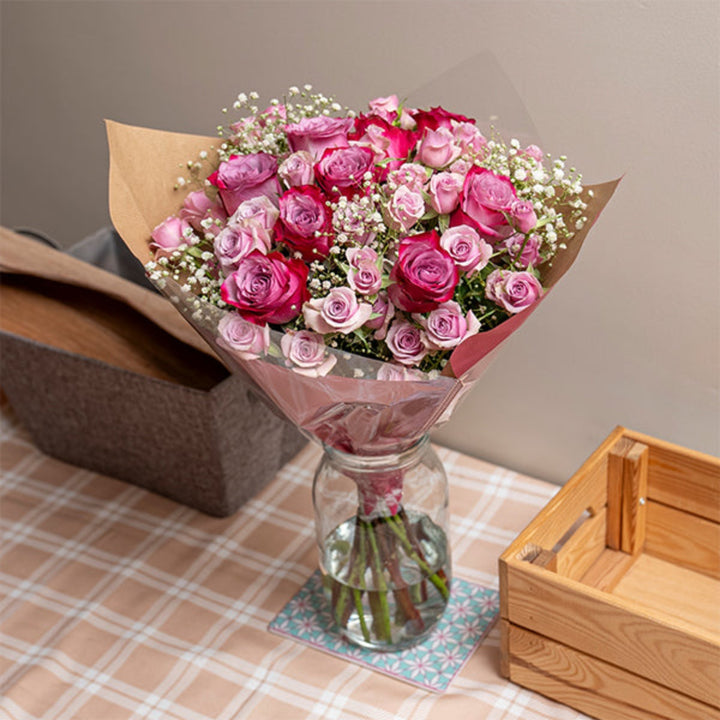 Beautiful roses bouquet with 23 purple and pink blooms from Mix Flower Bouquet, showcasing a luxurious floral arrangement.