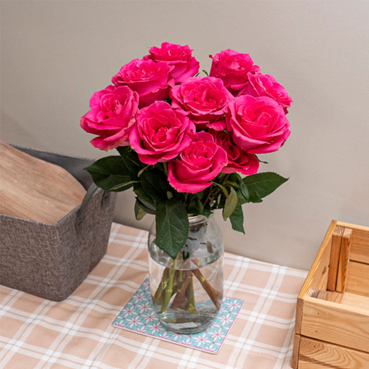 Fresh pink roses from Annakrya by Vegpro Kenya, showing 10 stems arranged with vibrant blossoms and green foliage.