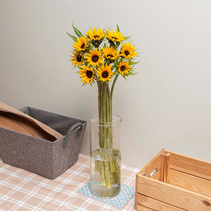 Bright yellow sunflower bouquet with 10 stems, featuring fresh blooms and green leaves, arranged by Black Tulip.