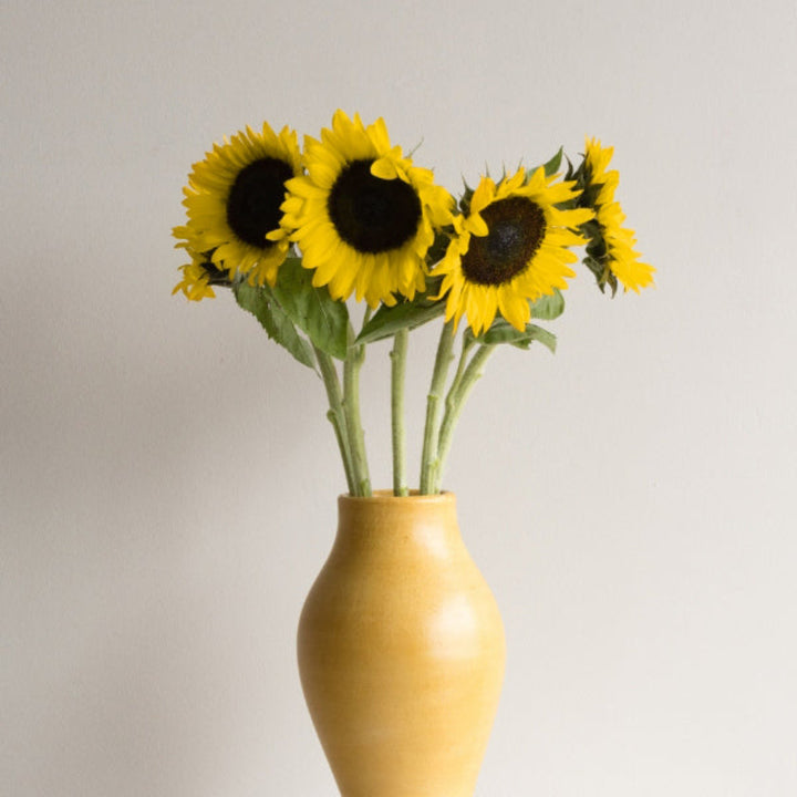Bright sunflower stems with yellow blooms from Sunrich Lemon variety by Flowranow, arranged in a bouquet.