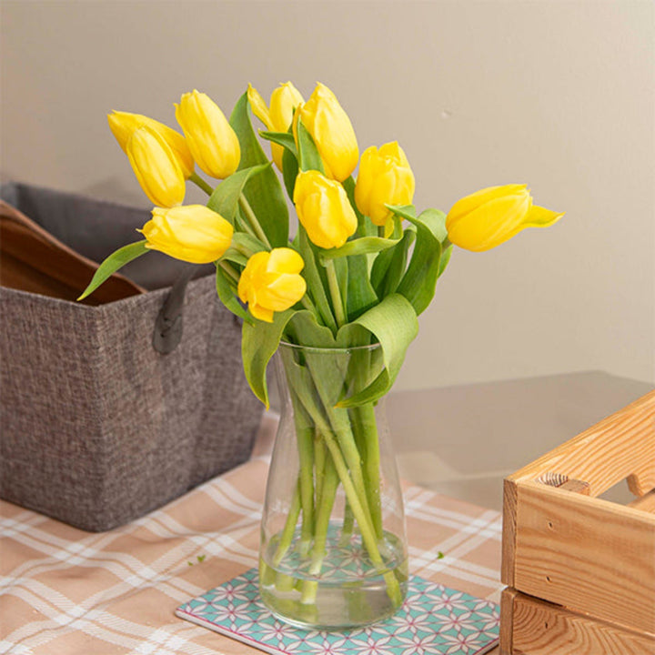 Bright yellow tulips from Fresh Flower Holland with 10 stems, showcasing vibrant blooms and fresh green leaves.