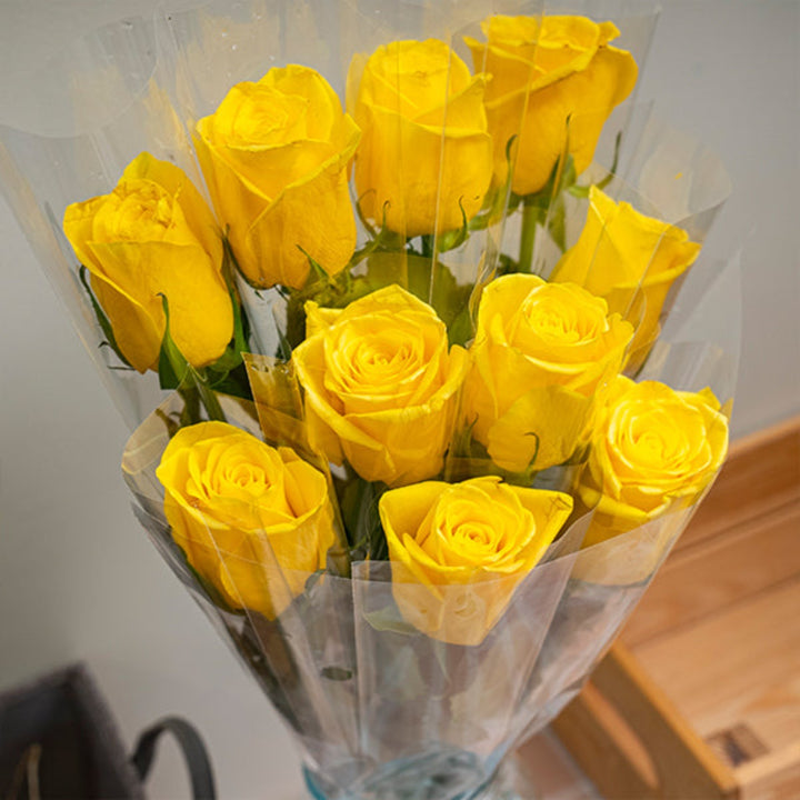 Bright yellow rose flower from SQ Flora Kenya, individually wrapped single stem with vibrant petals and fresh foliage.