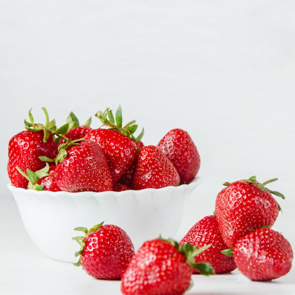 Fresh Driscoll's strawberries in a 0.25 kg pack, vibrant red berries with green leaves, on a white background.