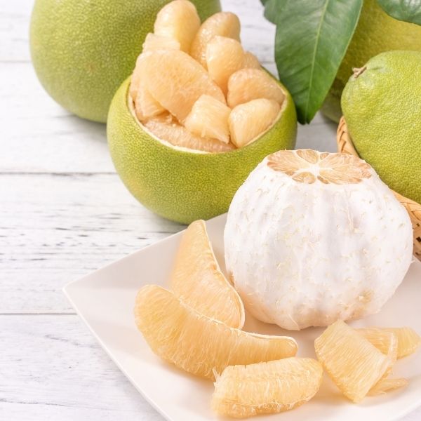 Fresh whole Sharbatly pomelo fruit, large and bright yellow, with smooth textured skin, ready for eating or juicing.