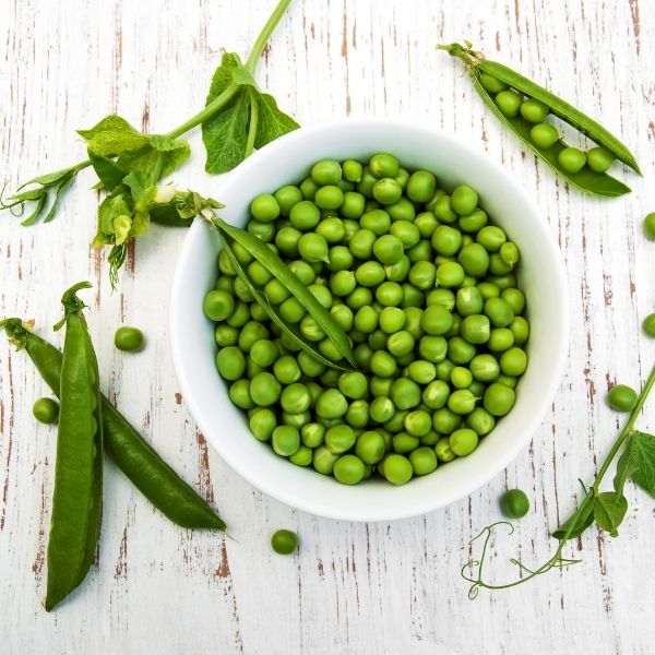 Fresh green peas in pod from Local Market, 0.5 kg pack, showcasing vibrant peas inside the pod on a white background.