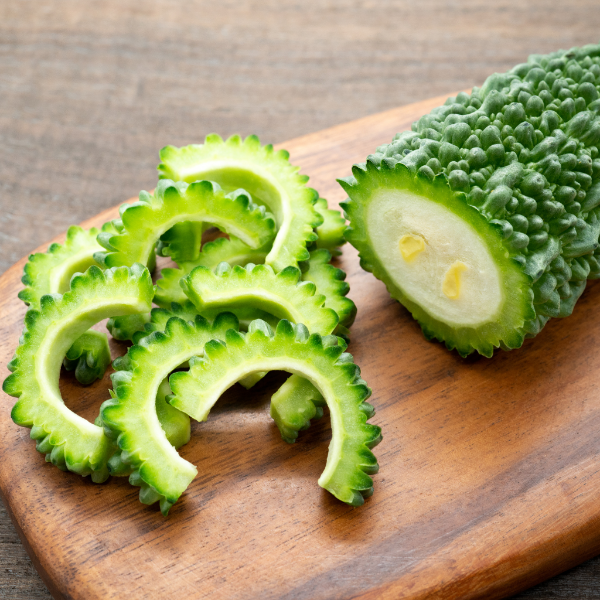 Fresh bitter gourds or bitter melons from Local Market, 1 kg bag, showcasing green, textured vegetables ideal for cooking.