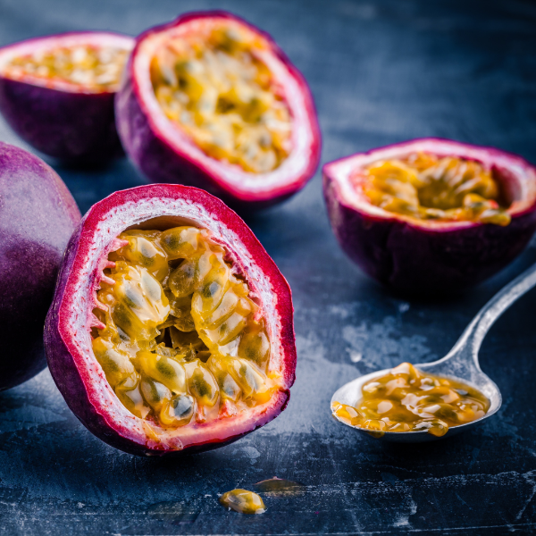 Holland passion fruit in a 0.5 kg pack, showing vibrant yellow-orange outer skin and fresh interior with seeds.