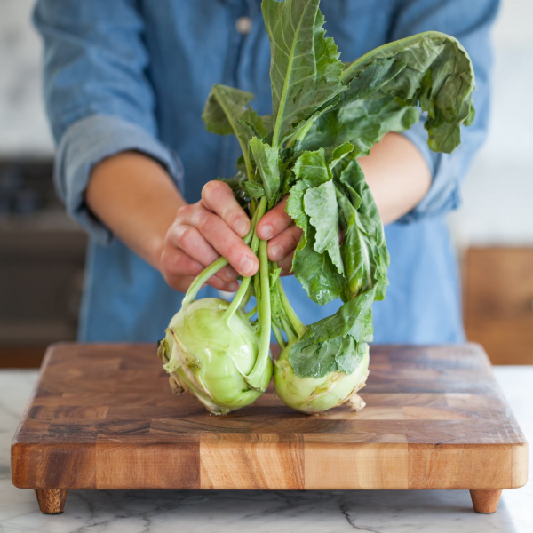 Fresh green kohlrabi vegetables, two pieces, from Local Market, with round bulbs and leafy stems visible.