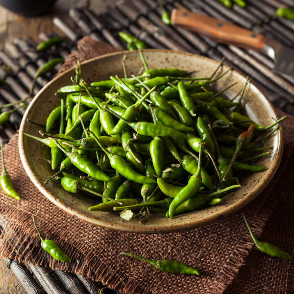 Fresh baby Thai green chilies from Thailand, shown in a 0.1 kg herb pack, with vibrant green chili peppers visible in the image.