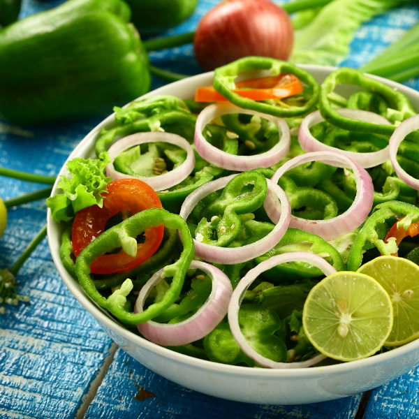 Fresh green capsicum peppers in a 1 kg pack from Local Market, vibrant vegetables perfect for salads and cooking.