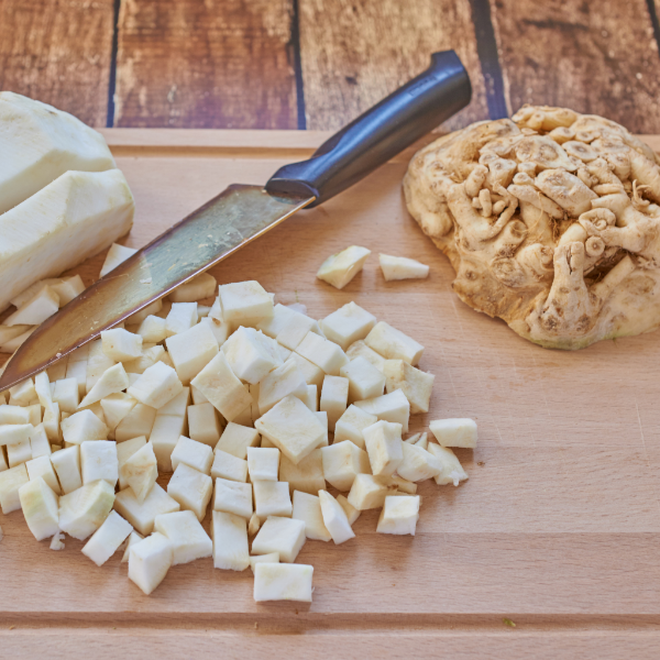 Fresh Holland celery root (celeriac), a single whole vegetable with rough brown skin and leafy top, ready for cooking or peeling.