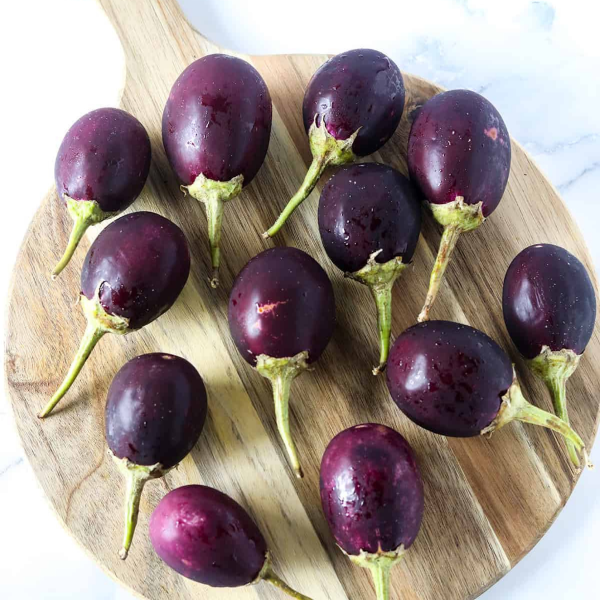 Fresh baby eggplants from Local Market, 1 kg pack, vibrant purple vegetables ideal for cooking or salads.