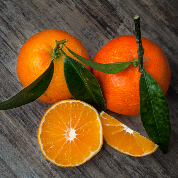Fresh leafy Clementines from Sharbatly in a 1 kg pack, showcasing bright orange fruit with green leaves.