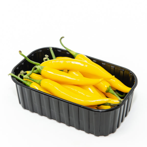 Yellow Cayenne chili pepper herb from Holland, fresh and vibrant, showcasing bright yellow cayenne peppers in a natural setting.