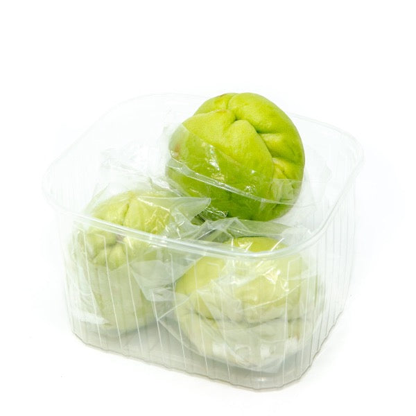 Fresh green chayote squash in a 1 kg pack, showcasing the vegetable's smooth, light green surface and natural shape.