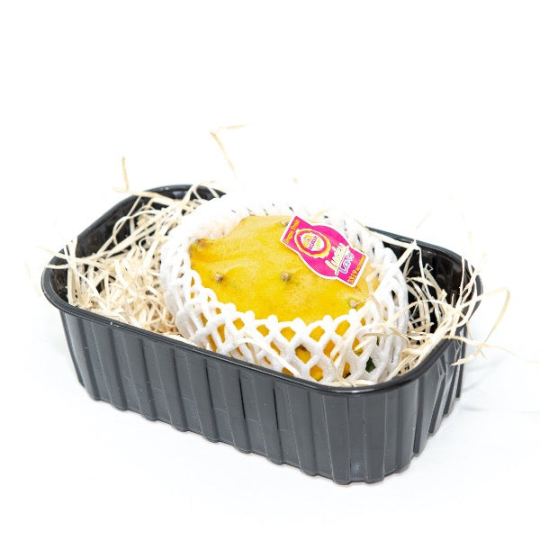 Yellow dragon fruit (pitaya) from Holland, single fresh fruit with vibrant yellow skin and white flesh visible inside.