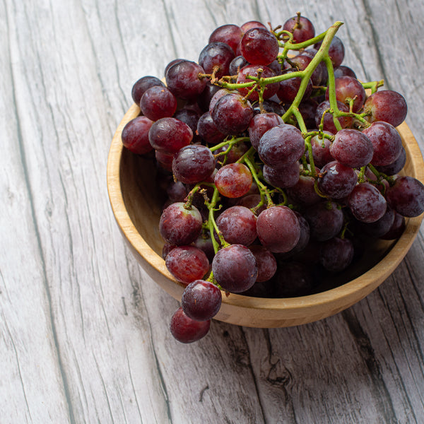 Red seedless grapes from Sharbatly in a 1.5 kg pack, fresh and plump fruit with vibrant color and smooth skin.