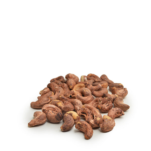 Grilled cashews with peel from Fresh Nuts, 0.45 kg pack, showing golden-brown roasted nuts in a natural setting.