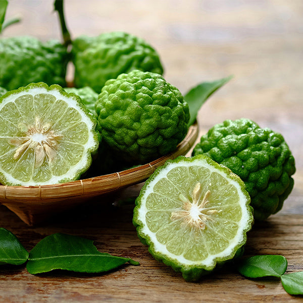 Fresh Thai kaffir limes in a 0.25 kg pack, vibrant green citrus fruit with aromatic leaves, used in cooking and garnishes.
